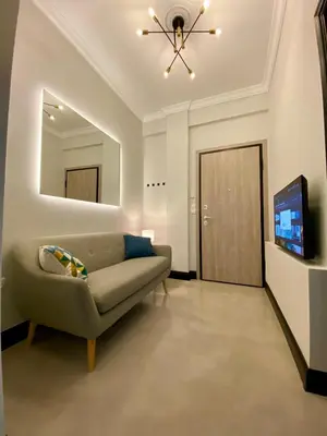 a living room with a couch and a flat screen tv at Elegant apartment in Kypseli in Athens