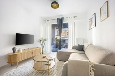 a living room with a couch and a tv at Andria's Apartment in Athens