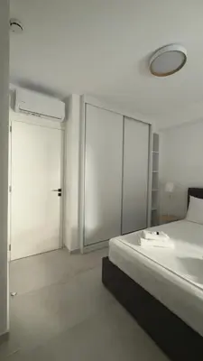a bedroom with a bed and sliding glass doors at Andria's Apartment in Athens