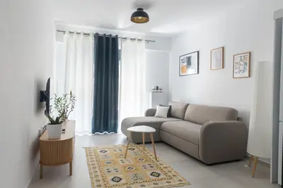 a living room with a couch and a table at Andria's Apartment in Athens