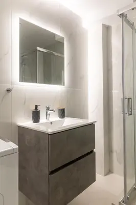 a bathroom with a sink and a mirror at Andria's Apartment in Athens