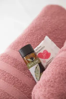 a bottle of lipstick on a pink towel at Ilissos Harmony Apartment in Piraeus