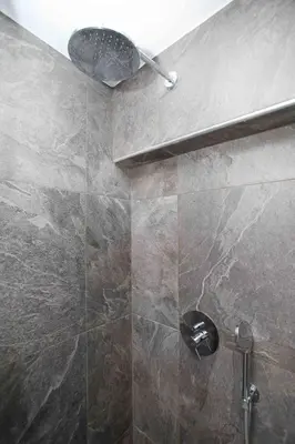 a bathroom with a shower with a ceiling at Ilissos Harmony Apartment in Piraeus