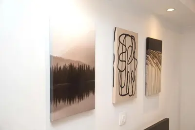 two pieces of art hanging on a wall at Ilissos Harmony Apartment in Piraeus