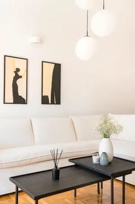a living room with a white couch and a black coffee table at Acropolis view, in the center of Athens! 4pl in Athens