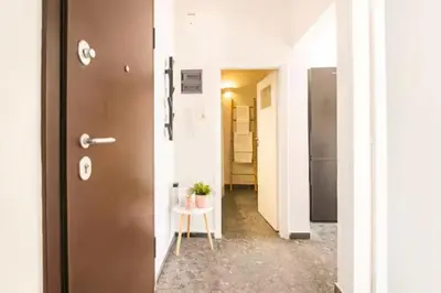a hallway with a door and a table with a plant at Acropolis view, in the center of Athens! 4pl in Athens