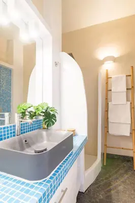 a bathroom with a sink and a blue tiled counter at Acropolis view, in the center of Athens! 4pl in Athens