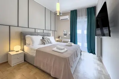 a bedroom with a bed and a television in it at Boutique Athens Flat in Koukaki, Walk to Acropolis in Athens