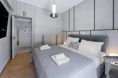 a bedroom with a large bed with two towels on it at Boutique Athens Flat in Koukaki, Walk to Acropolis in Athens