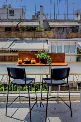 two chairs and a table with a plate of food on it at Boutique Athens Flat in Koukaki, Walk to Acropolis in Athens