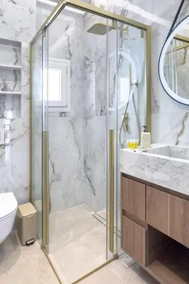 a bathroom with a shower and a toilet and a sink at Boutique Athens Flat in Koukaki, Walk to Acropolis in Athens