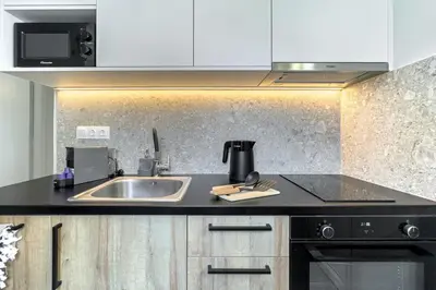 a kitchen with a sink and a counter top at Boutique Athens Flat in Koukaki, Walk to Acropolis in Athens