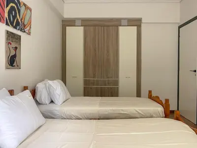 two beds sitting next to each other in a bedroom at Alegria's 2BR Garden Apartment in Athens