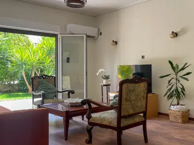 a living room with a table and two chairs at Alegria's 2BR Garden Apartment in Athens