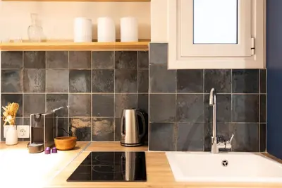 a kitchen with a sink and a counter top at Pagrati Art & Love in Athens