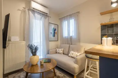 a living room with a couch and a table at Pagrati Art & Love in Athens