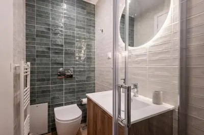 a bathroom with a toilet and a sink and a mirror at Pagrati Art & Love in Athens