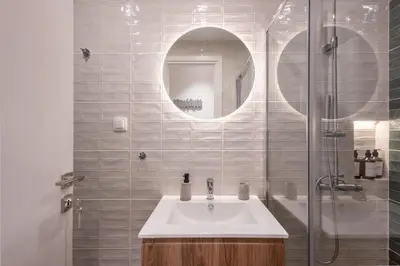 a bathroom with a sink and a glass shower at Pagrati Art & Love in Athens