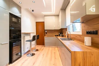 a kitchen with a wooden counter top and a sink at Cozy 2-Bedroom by Flisvos Marina in Athens