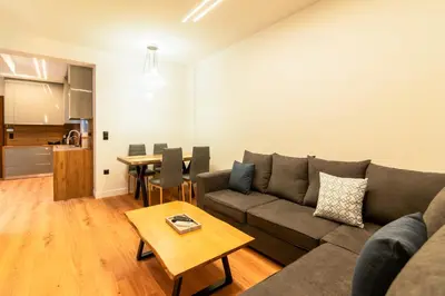 a living room with a couch and a table at Cozy 2-Bedroom by Flisvos Marina in Athens
