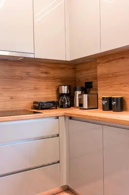 a kitchen with white cabinets and a counter top at Cozy 2-Bedroom by Flisvos Marina in Athens