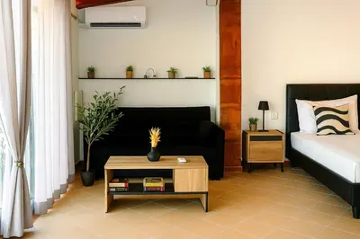 a living room with a bed and a coffee table at Panathenea Rooftop Apartment with Stunning View of Lycabettus in Athens