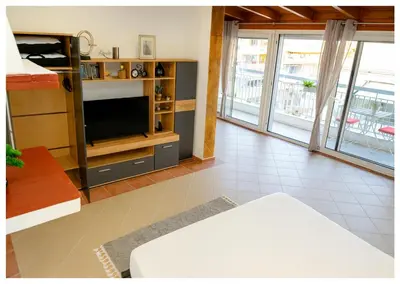 a living room with a tv and a couch at Panathenea Rooftop Apartment with Stunning View of Lycabettus in Athens