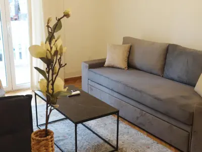 a living room with a couch and a coffee table at Shoni home in Piraeus