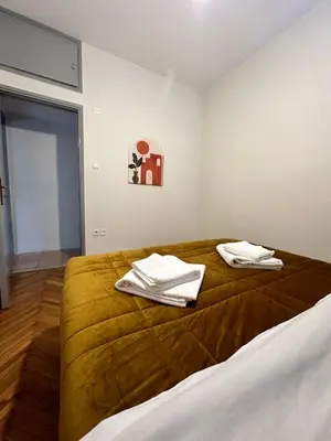a bedroom with a bed with towels on it at Shoni home in Piraeus
