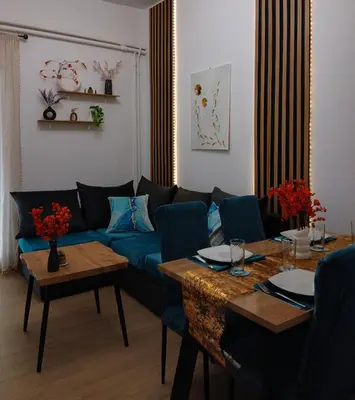 a living room with a blue couch and tables at Mountain Haven - Japandi Style With 100Mbps Wi-Fi in Athens