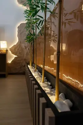 a row of bamboo trees on a wall with rocks at Mountain Haven - Japandi Style With 100Mbps Wi-Fi in Athens