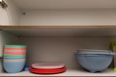 a group of plates and bowls on a shelf at Mountain Haven - Japandi Style With 100Mbps Wi-Fi in Athens