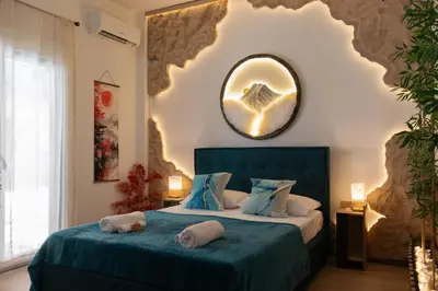 a bedroom with a bed with a mirror on the wall at Mountain Haven - Japandi Style With 100Mbps Wi-Fi in Athens