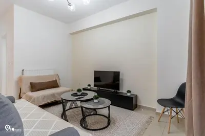 a living room with a couch and a tv at Emeralds - Premium & Modern Stay in Egaleo-Athens in Athens