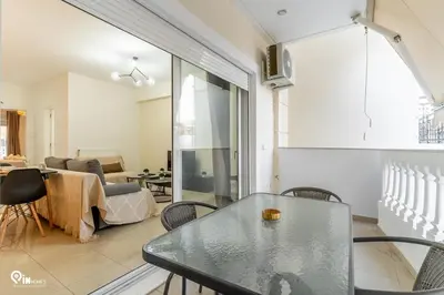 a living room with a glass table and chairs at Emeralds - Premium & Modern Stay in Egaleo-Athens in Athens