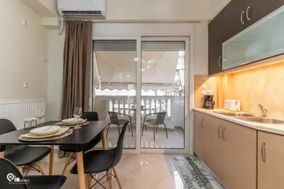 a kitchen and dining room with a table and chairs at Rubies - Premium And Comfy Stay in Egaleo-Athens in Athens
