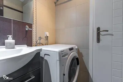 a bathroom with a washing machine and a sink at Rubies - Premium And Comfy Stay in Egaleo-Athens in Athens
