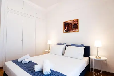 a bedroom with a bed with towels on it at Syntagma square, 60sqm Fancy apartment in Athens