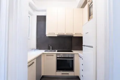 a kitchen with white cabinets and a sink at Syntagma square, 60sqm Fancy apartment in Athens