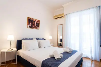 a bedroom with a bed with two towels on it at Syntagma square, 60sqm Fancy apartment in Athens