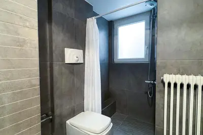 a bathroom with a toilet and a window and a shower at Syntagma square, 60sqm Fancy apartment in Athens