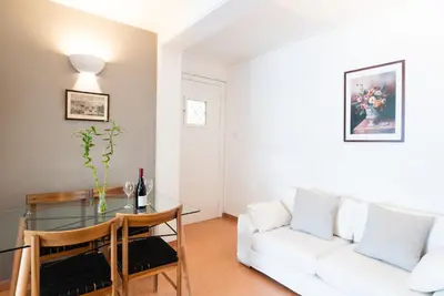 a living room with a white couch and a glass table at Syntagma square, 60sqm Fancy apartment in Athens