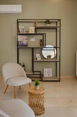 a room with a chair and a mirror and a table at The Hidden Muse 3BD Free Parking in Athens