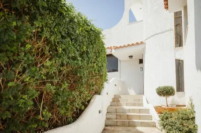 a stairway leading up to a white house at The Hidden Muse 3BD Free Parking in Athens