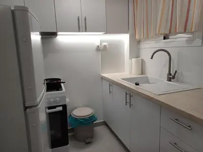 a small kitchen with a sink and a refrigerator at Harmony Athens city apartment in Athens
