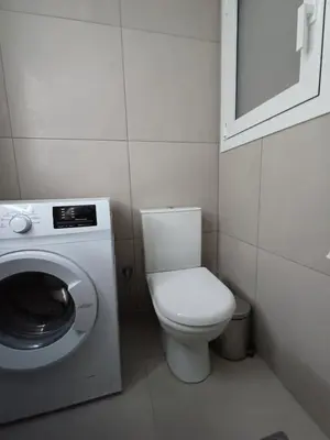 a small bathroom with a toilet and a washing machine at Harmony Athens city apartment in Athens