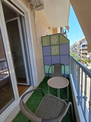 a balcony with two chairs and a table at Harmony Athens city apartment in Athens
