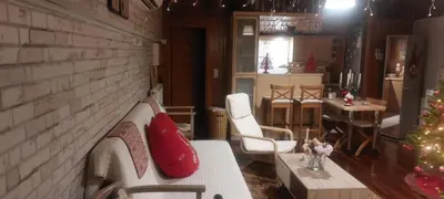 a living room with a couch and a christmas tree at Rooftop bliss in Athens