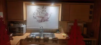 a kitchen with a sink and a tea pot on the window at Rooftop bliss in Athens