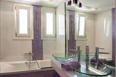 a bathroom with two glass sinks and a tub at GT Dreams Villa - Luxury Villa near the Athenian Riviera in Vari
